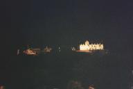 Edinburgh castle at night with festival lights.
